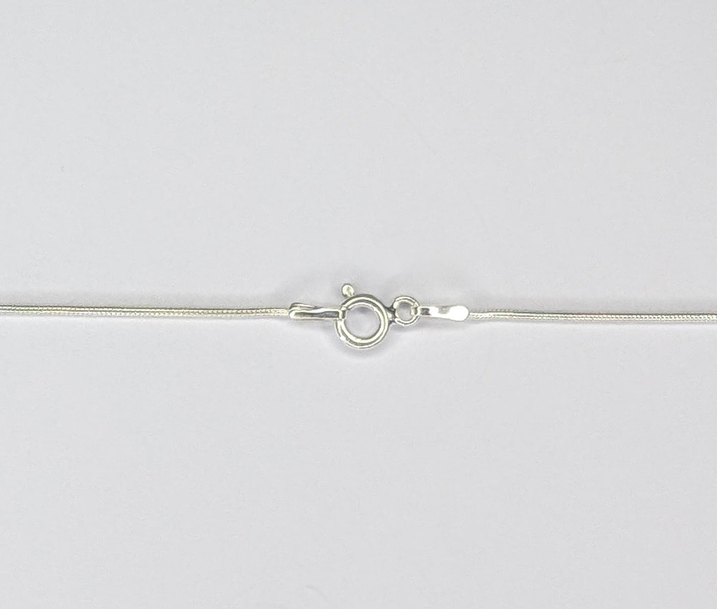 Long twizzle pendant in dark sterling silver with white coin pearl on mini snake chain.