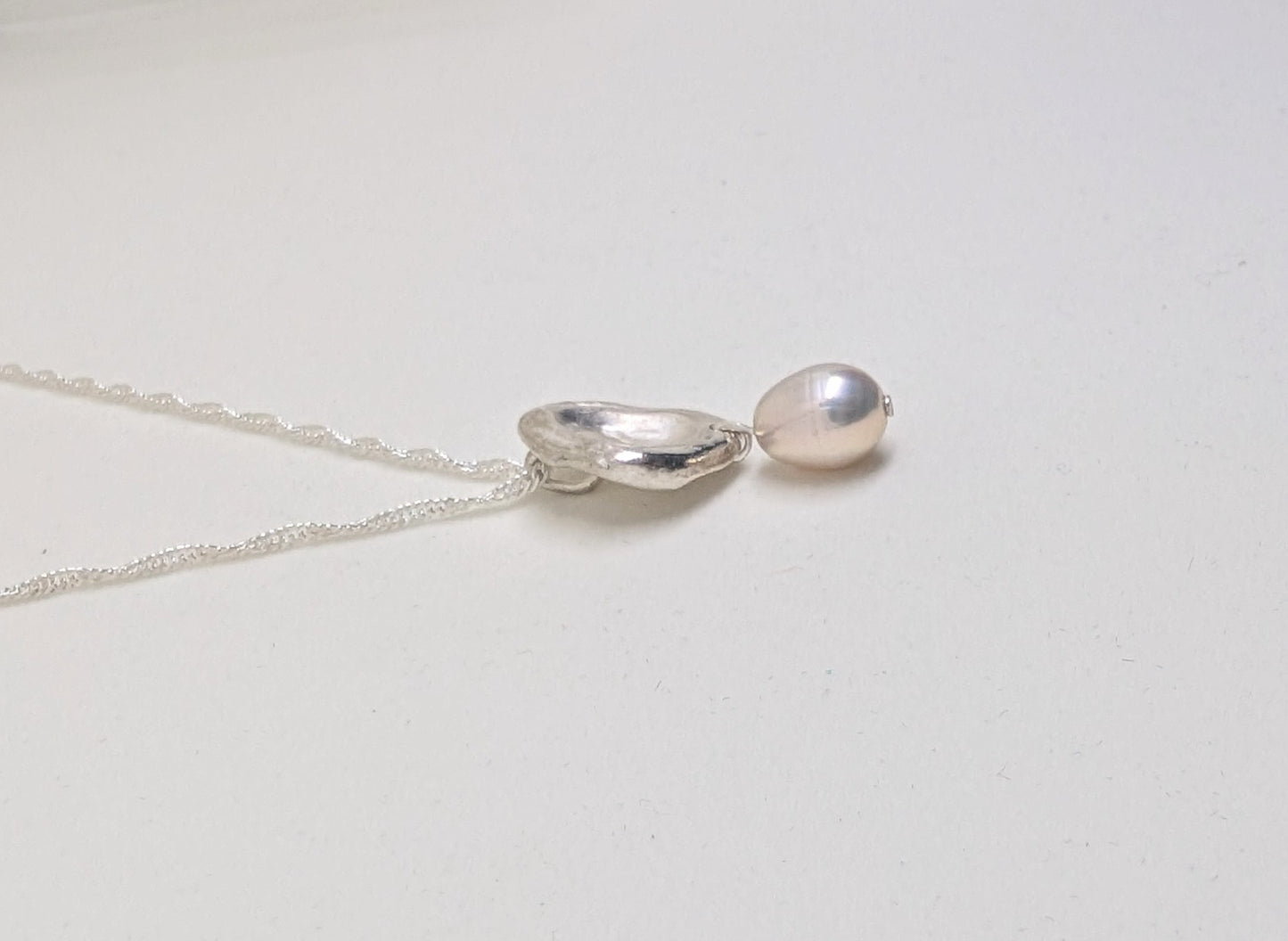 Silver splash pendant with oval cultured freshwater pearl
