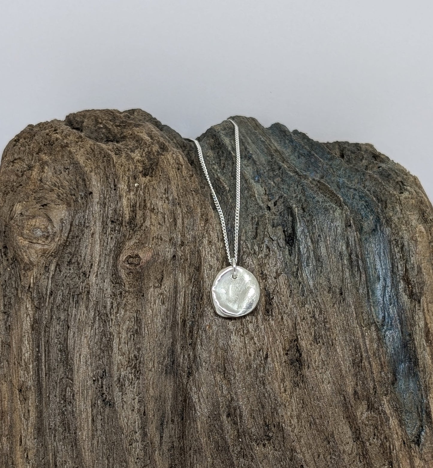 Reversible silver splash pendant