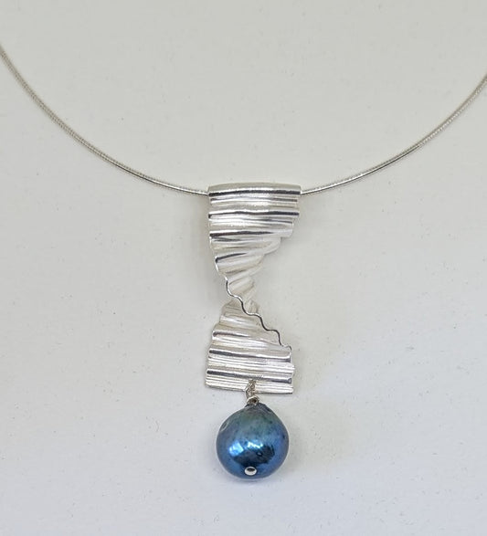 Large silver ripple pendant with large blue pearl