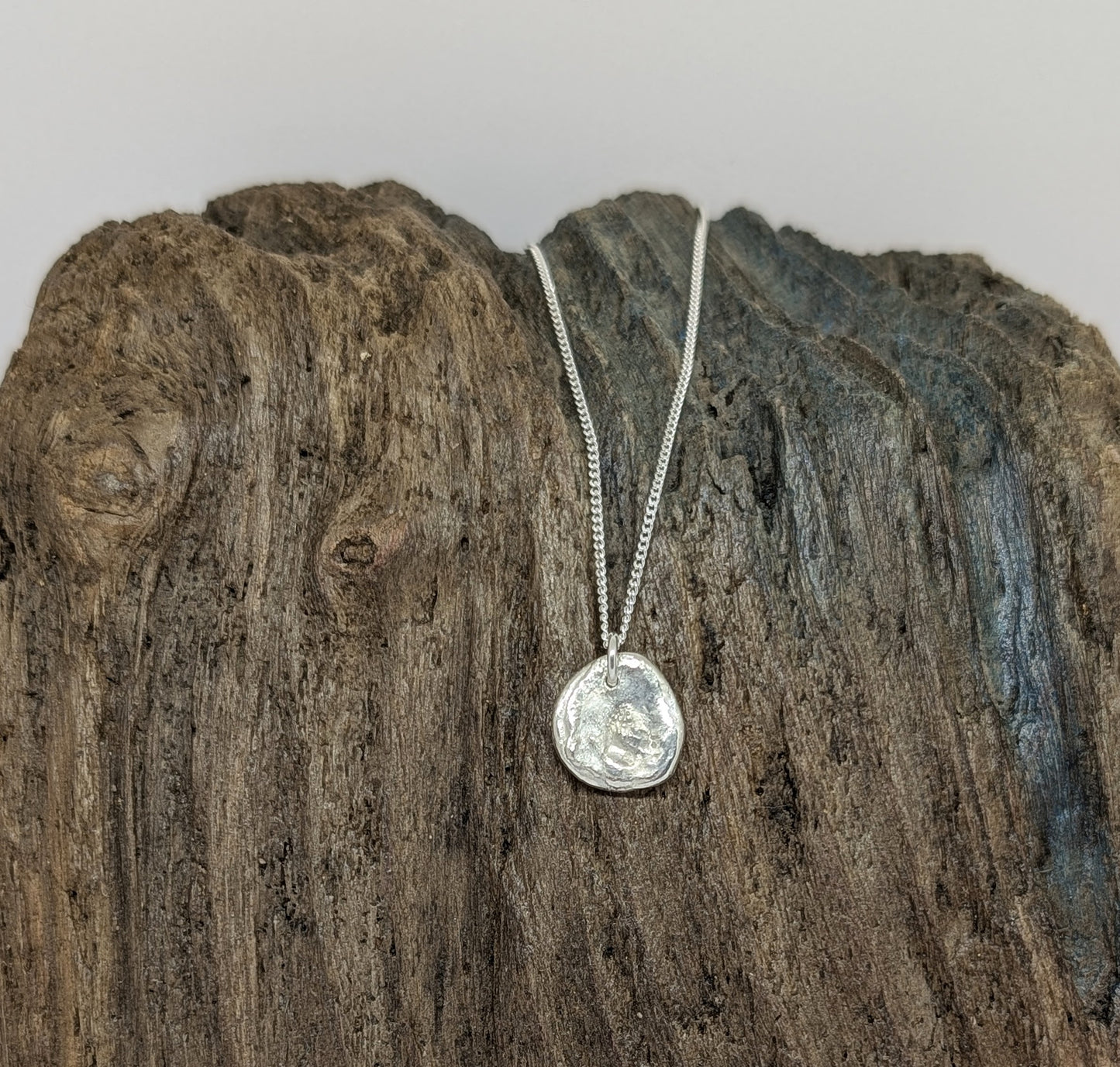 Reversible silver splash pendant