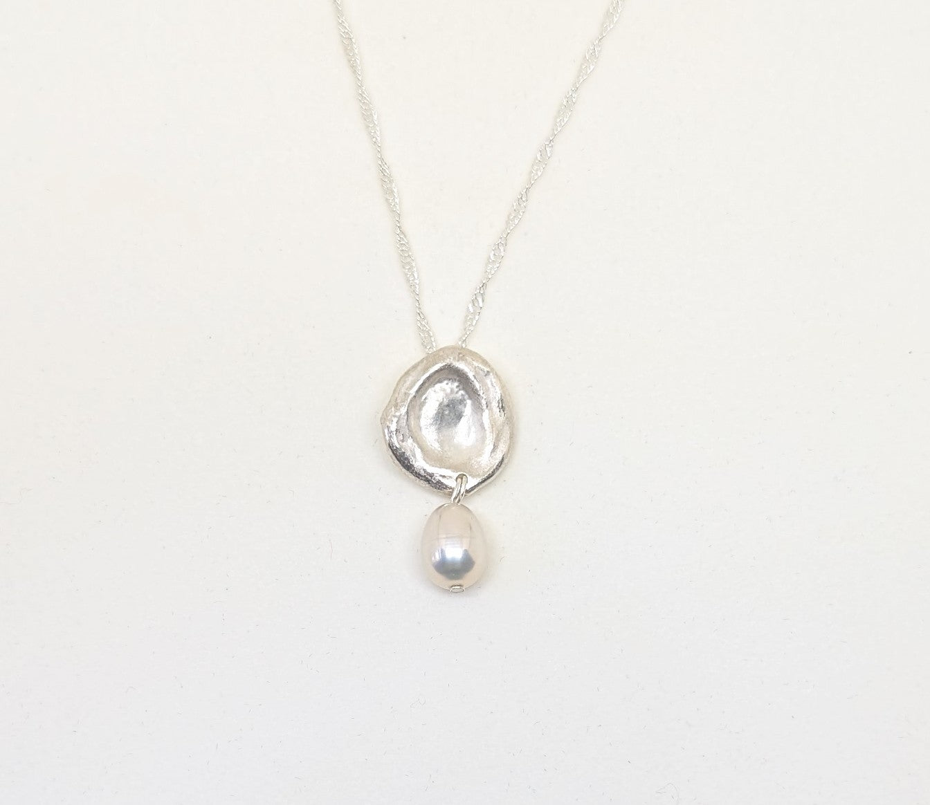 Silver splash pendant with oval cultured freshwater pearl