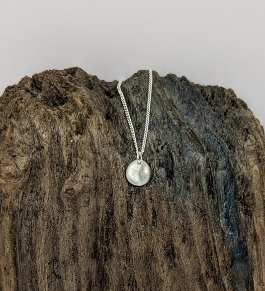 Reversible silver splash pendant