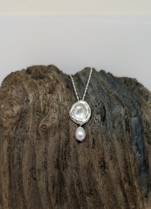 Silver splash pendant with oval freshwater pearl