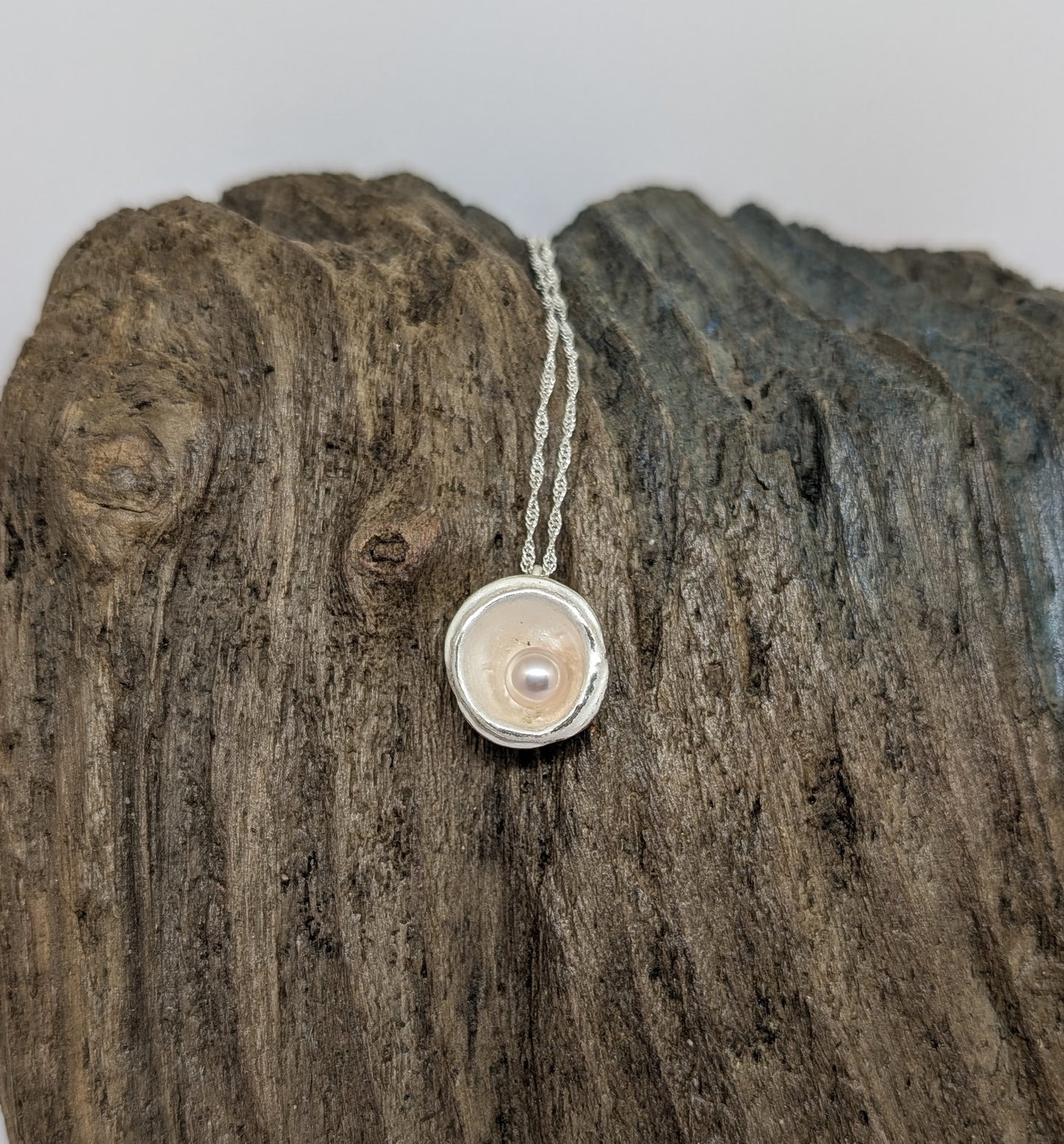 Silver splash pendant with freshwater pearl with delicate hues